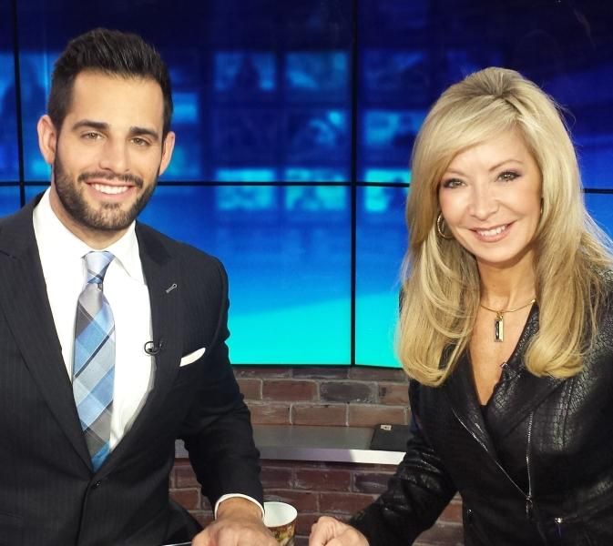 Catherine Bosley seated at a news anchor desk with another presenter.