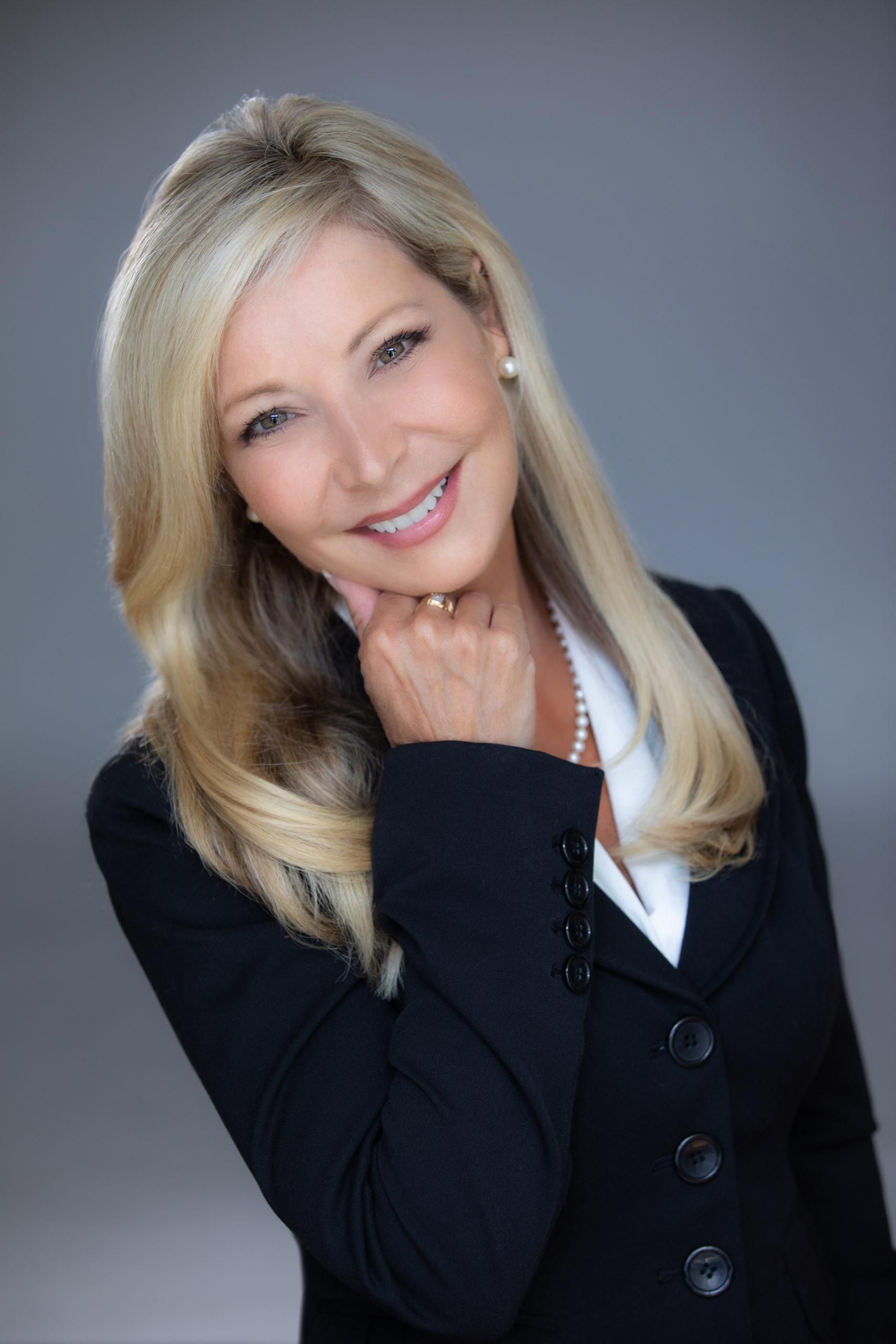 Catherine Bosley, a professional portrait with her hand resting at her chin.